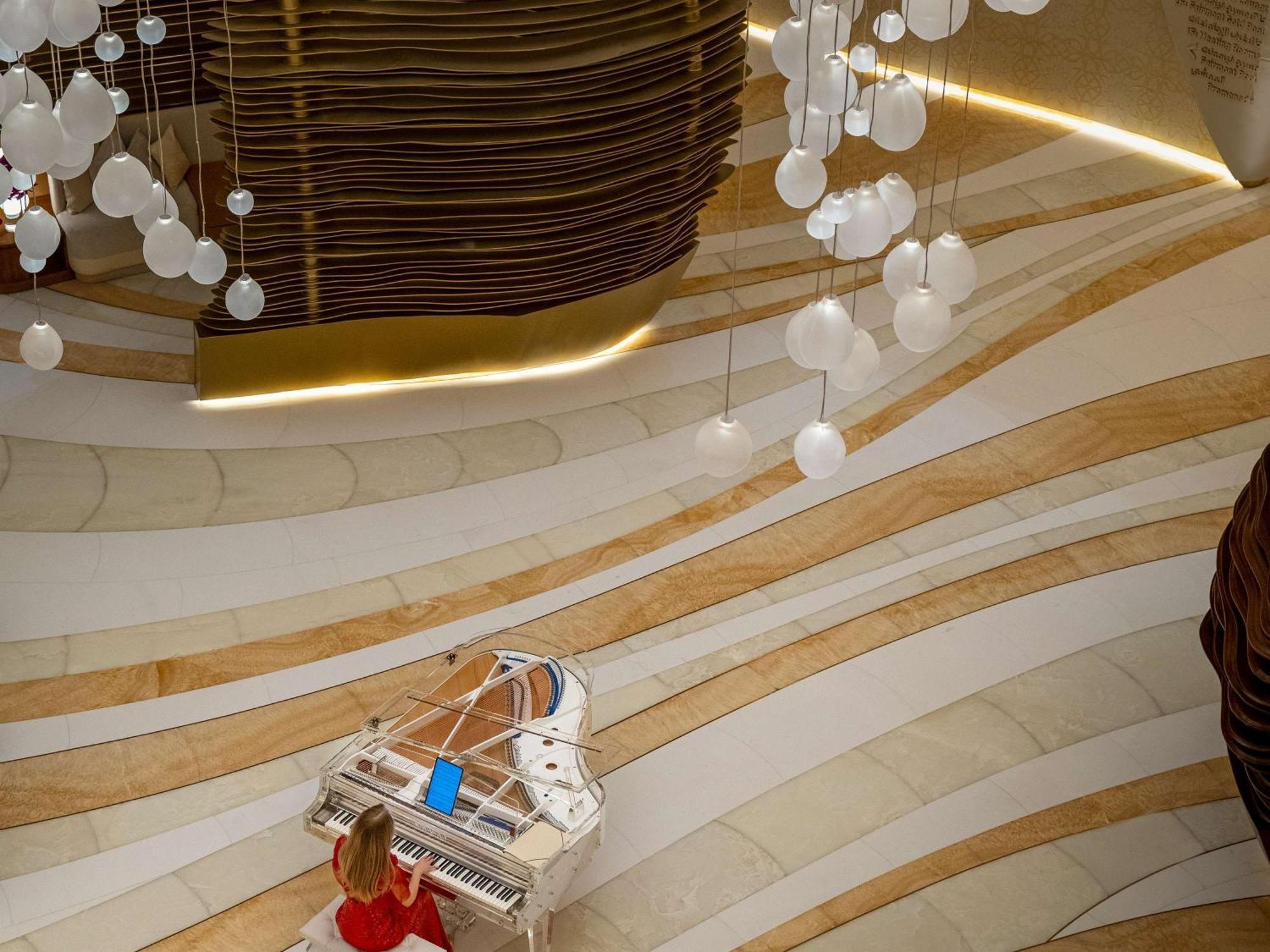 Fairmont Doha Hotel Lusail Exterior photo The piano in the lobby