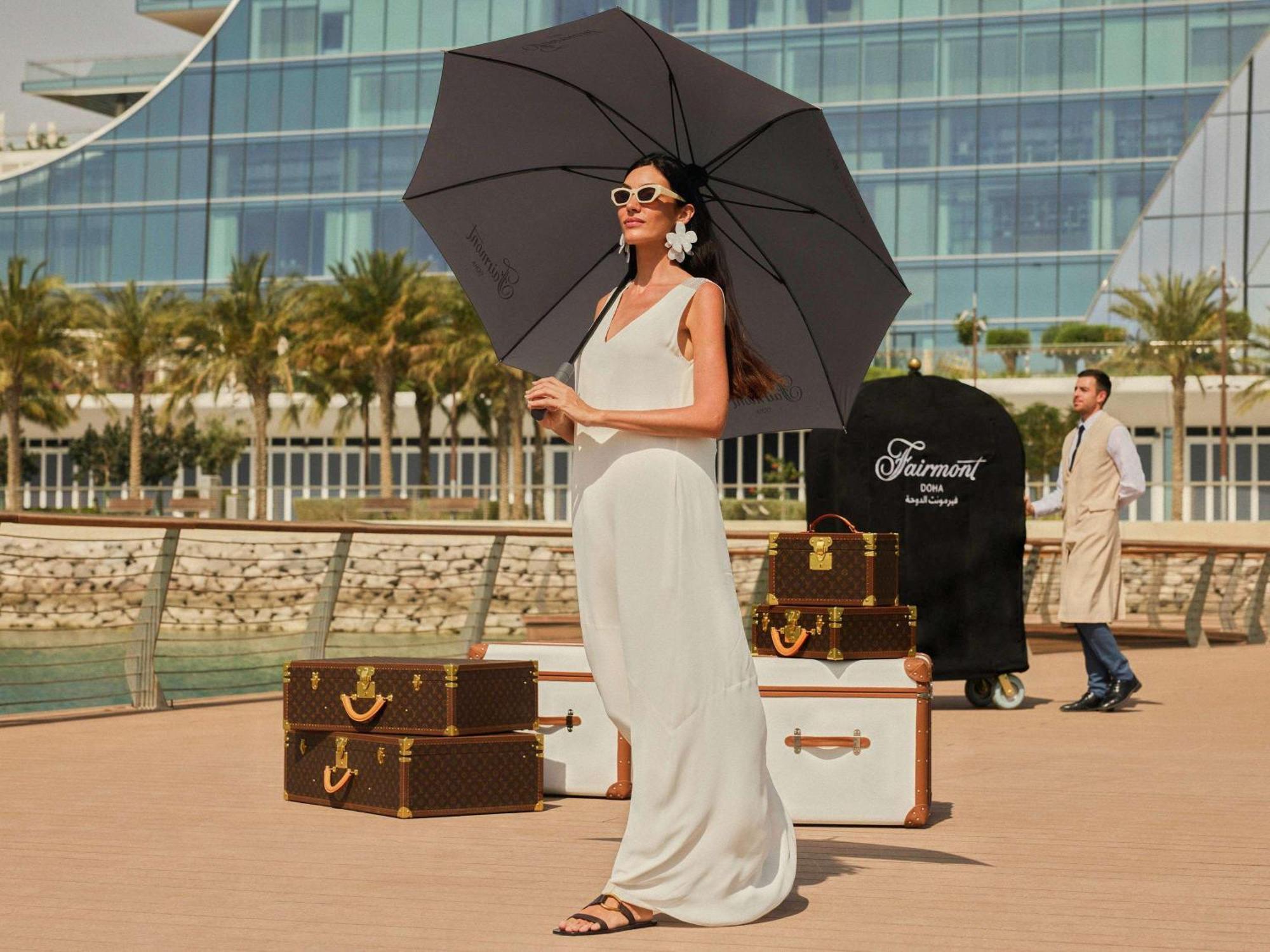 Fairmont Doha Hotel Lusail Exterior photo A woman with a large umbrella